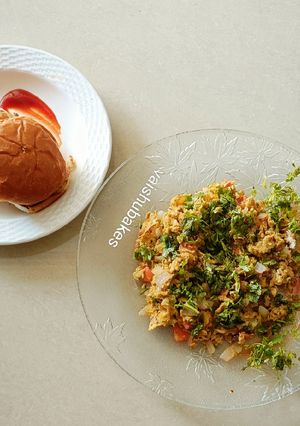 A picture of Egg Bhurji with Paav/ scrambled eggs and buns.
