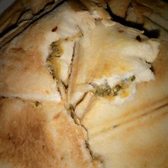 A picture of Toasted bread with veg saurce.