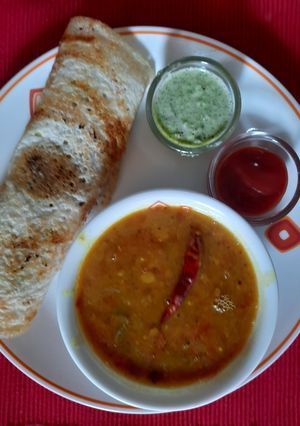 A picture of Dosa with Sambhar and coconut chutney.