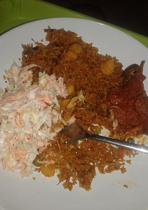 A picture of Shrimp Basmati Jollof Rice with Cole slaw and stewed n.