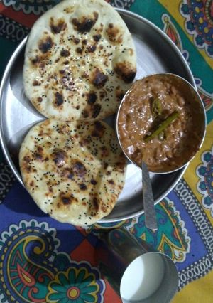 A picture of Butter naan with dal makhani.