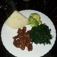 A picture of Fried Pork, greens and ugali.