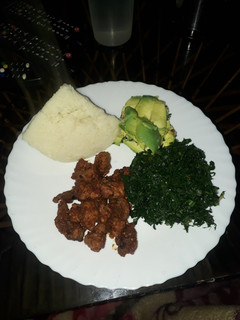 A picture of Fried Pork, greens and ugali.