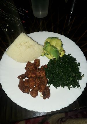 A picture of Fried Pork, greens and ugali.