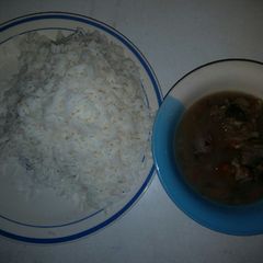 A picture of White rice with onion pepper soup.
