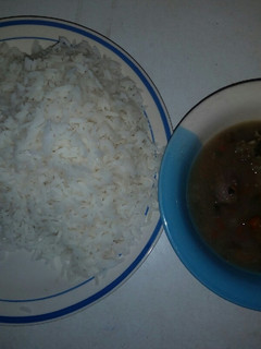 A picture of White rice with onion pepper soup.