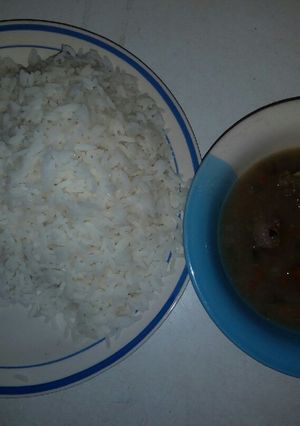 A picture of White rice with onion pepper soup.
