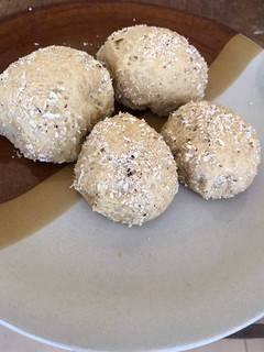A picture of Bread balls with coconut sprinkles.