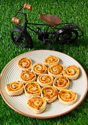 A picture of চিসী ক্যারোট পিনহুইল (Cheesy carrot pinwheel recipe in Bengali).