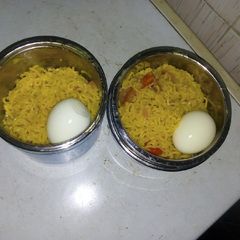 A picture of Indomie and veggies with boiled egg.
