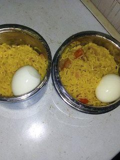 A picture of Indomie and veggies with boiled egg.