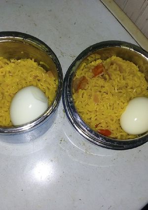 A picture of Indomie and veggies with boiled egg.