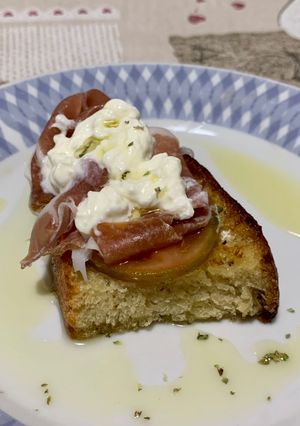 A picture of Bruschetta with Prosciutto and Stracciatella.