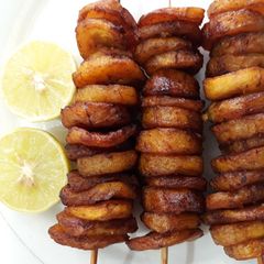 A picture of Fried plantain in skewer.