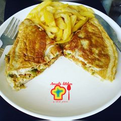 A picture of Veggies omelette with fried potatoes.