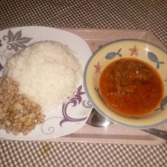 A picture of Rice and beans with stew.