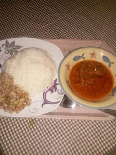 A picture of Rice and beans with stew.
