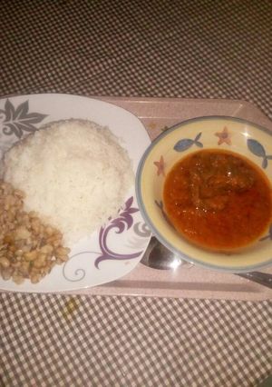 A picture of Rice and beans with stew.
