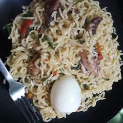 A picture of Noddles with egg,smoked fish and scent leaves.