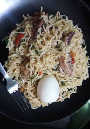 A picture of Noddles with egg,smoked fish and scent leaves.