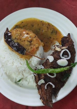A picture of Fried fish khati daal and plain rice.