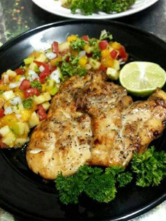 A picture of Grilled Chicken Steak with Black Pepper and Apple Mango Salsa.