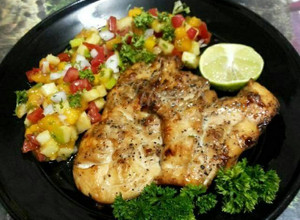 A picture of Grilled Chicken Steak with Black Pepper and Apple Mango Salsa.