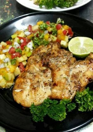 A picture of Grilled Chicken Steak with Black Pepper and Apple Mango Salsa.