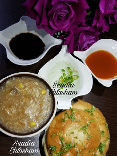 A picture of Chicken Oats soup with spiral garlic bun.