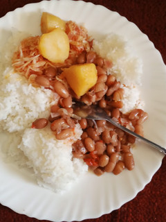 A picture of Rice with bean stew,cabbage and Irish potatoes.