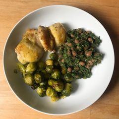 A picture of Roasted chicken thighs and veg with spinach and beans.