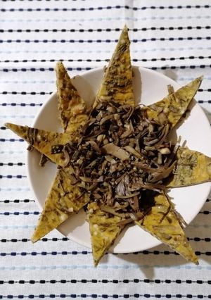 A picture of Artichoke Frittata Wedges on a Bed of Artichokes.