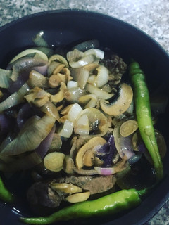 A picture of Pork Steak Tagalog w Steamed Onions and Mushrooms.