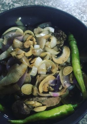 A picture of Pork Steak Tagalog w Steamed Onions and Mushrooms.
