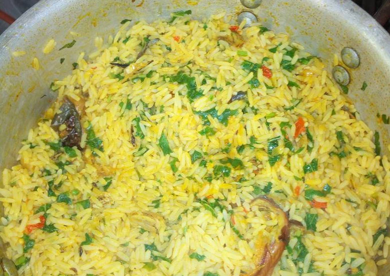 Jollof rice with dry fish and green leaf