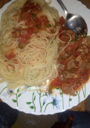 A picture of Spaghetti and wet fried beef.