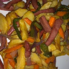 A picture of Chips and stir fry with sausage.