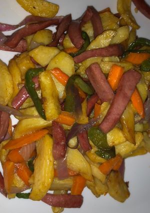 A picture of Chips and stir fry with sausage.