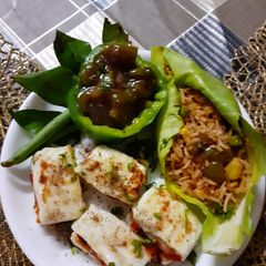 A picture of Fried rice with Manchurian gravy and paneer canapies.
