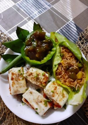A picture of Fried rice with Manchurian gravy and paneer canapies.