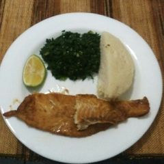 Grilled fish fillets with steamed kales and ugali A picture of Grilled fish fillets with steamed kales and ugali.