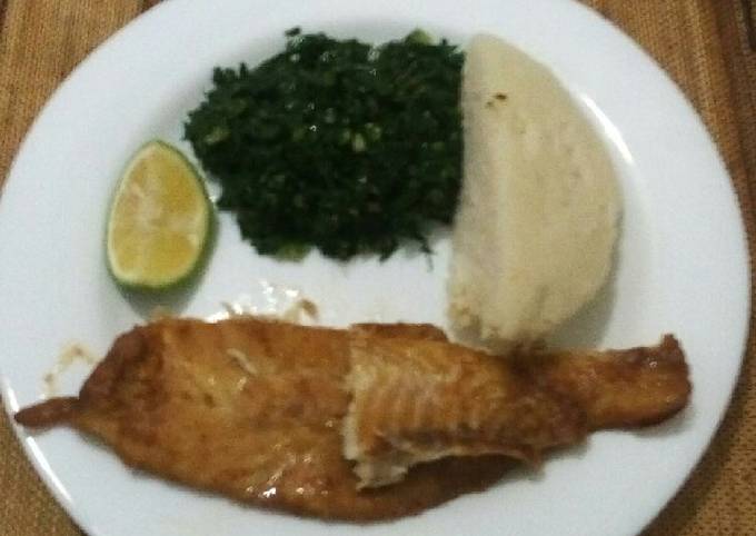 Grilled fish fillets with steamed kales and ugali
