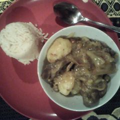 A picture of Lamb bones served with rice.