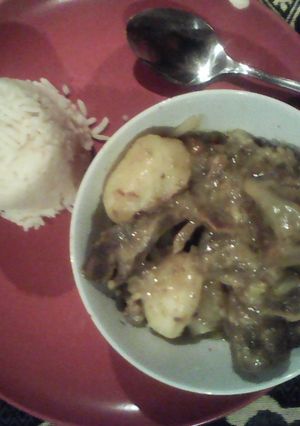 A picture of Lamb bones served with rice.