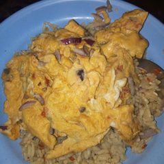 Jollof rice with fried egg A picture of Jollof rice with fried egg.