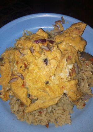 A picture of Jollof rice with fried egg.