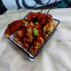 A picture of Crispy fried chicken wings with bbq sauce.