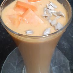 A picture of Papaya Pear Coconut Smoothie with Roasted Sunflower Seeds.