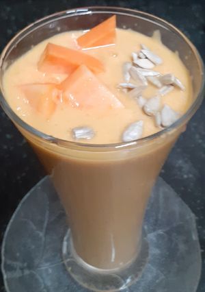 A picture of Papaya Pear Coconut Smoothie with Roasted Sunflower Seeds.