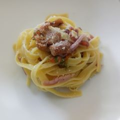 A picture of Tagliatelle with chanterelle mushrooms courgette flowers & speck.